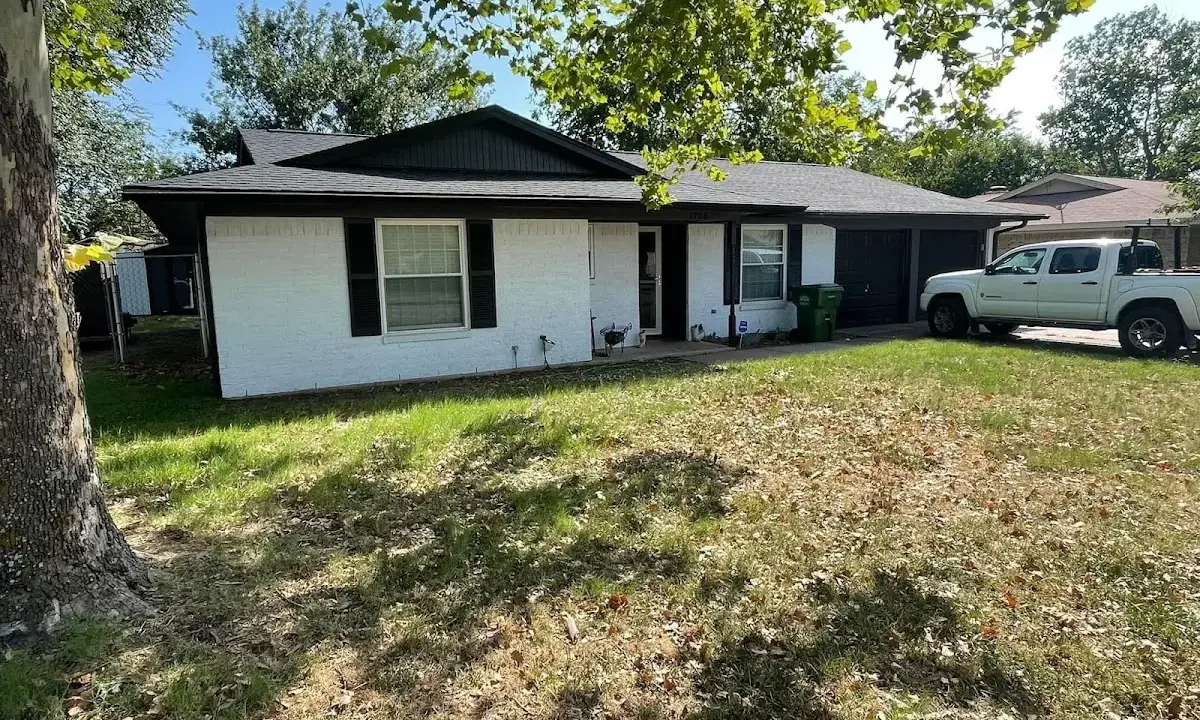 Professional roofing crew working on a residential roof in Livingston